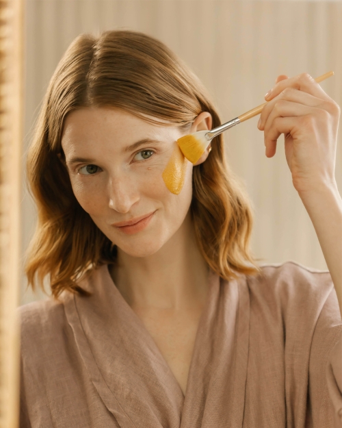 Woman brushing makeup on her face